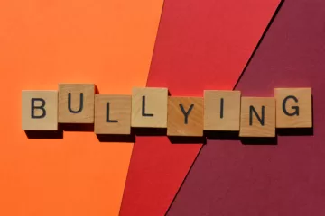 Autistic Teenagers and bullying, photo showing scrabble pieces spelling the word bullying on a colourful background